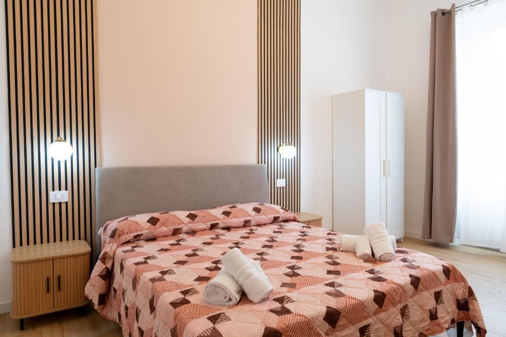 a bedroom with a bed with two pillows on it at Il Giardinetto Guest House in Civitavecchia