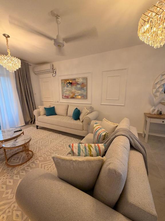 a living room with two couches and a couch at Kijani Luxury Beach apartment in Malindi