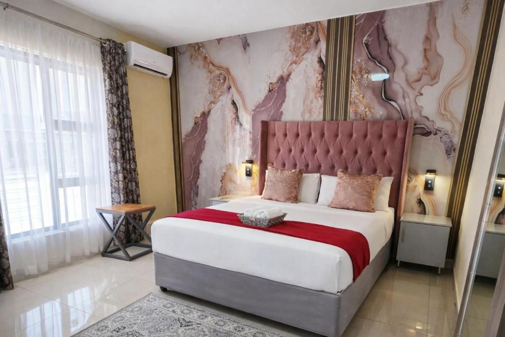 En eller flere senge i et værelse på MATAT GARDENS