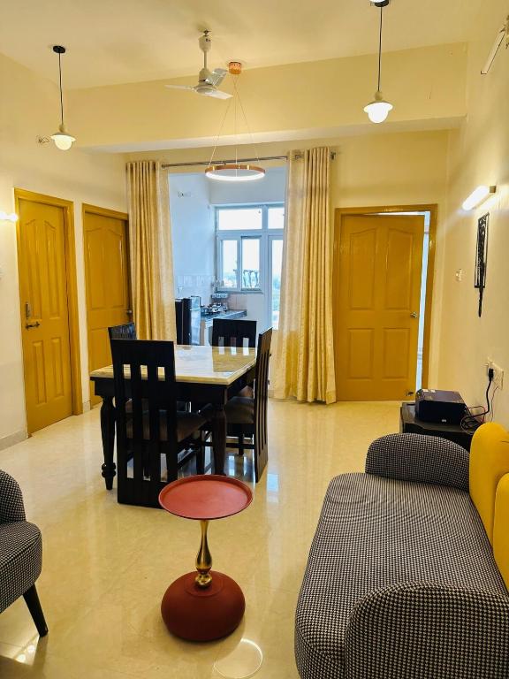 a living room with a table and chairs at Pitambar in Varanasi