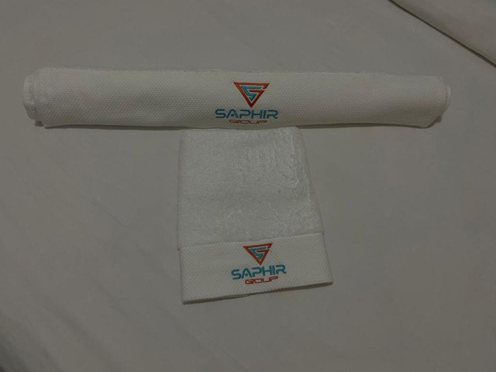 a pair of towels are hanging on a wall at Hotel Saphir Group in Douala
