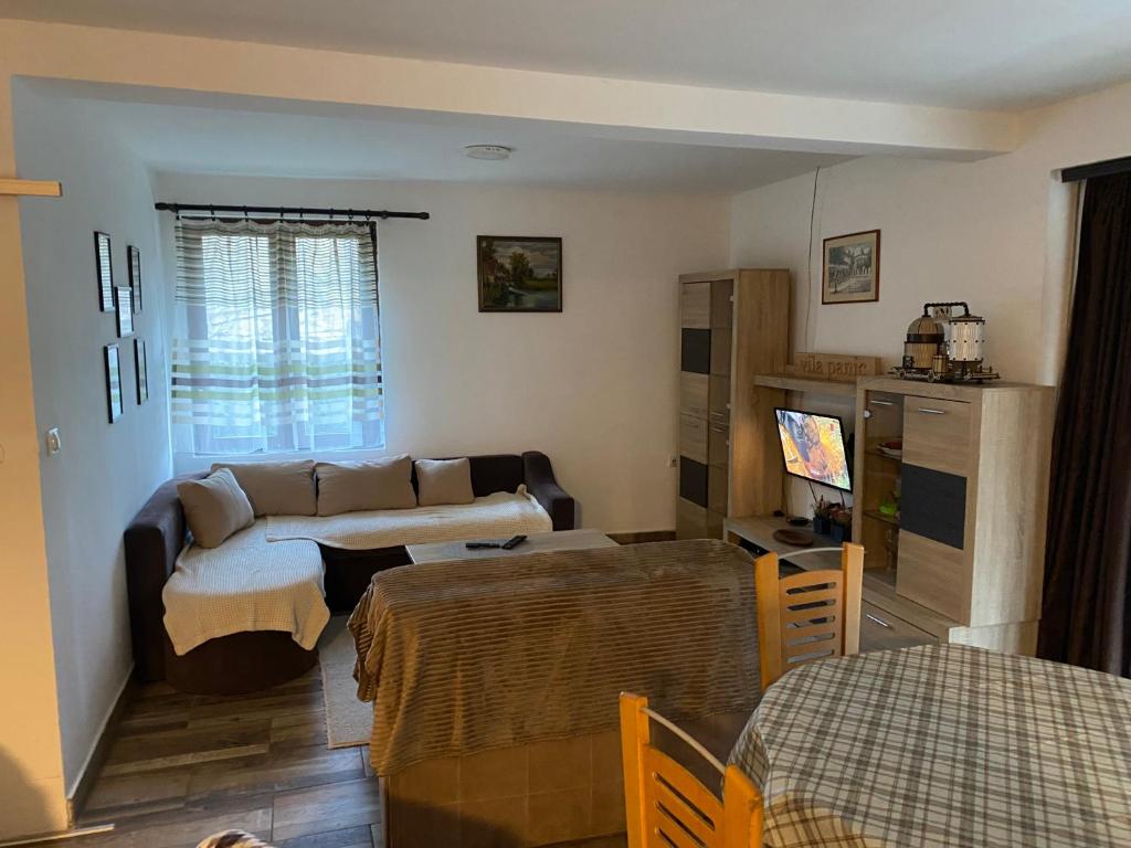a living room with a couch and a table at Vila Panic in Pirot