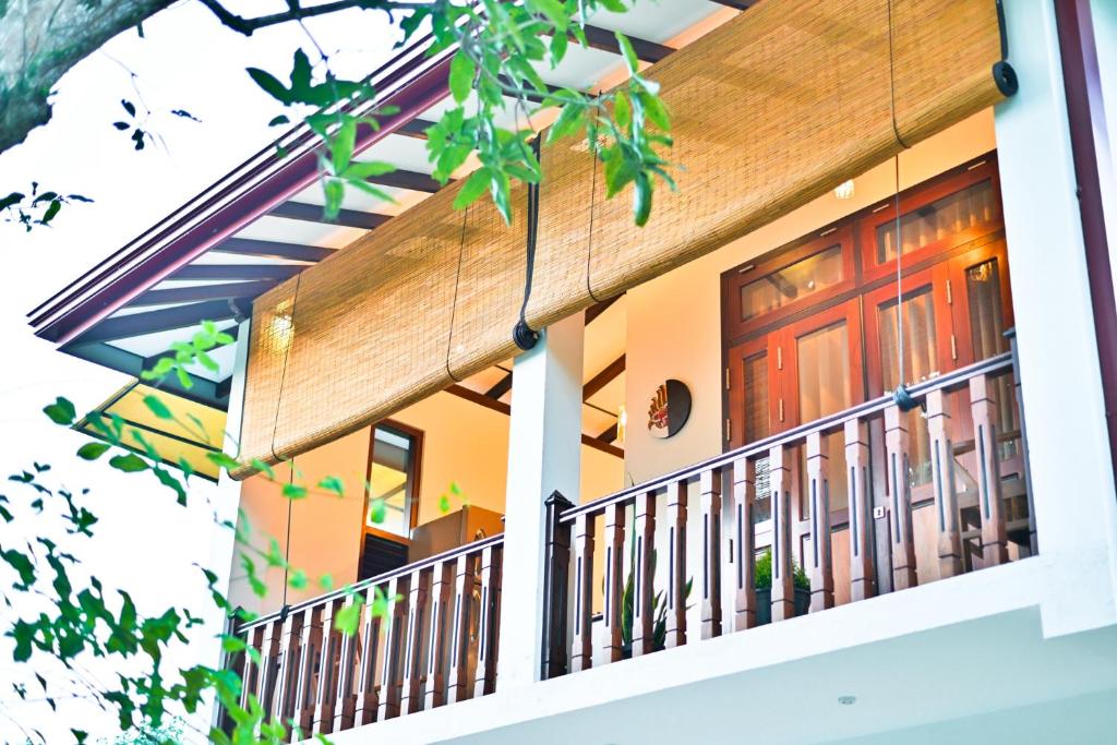 a house with a front porch with a wooden door at Mansion view in Unawatuna
