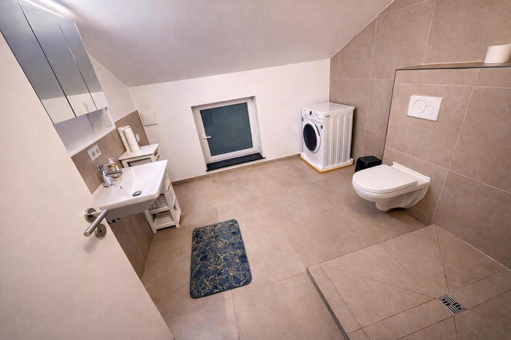 a bathroom with a toilet and a sink at Laichingen Center with style & tranquility in Laichingen
