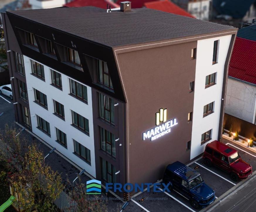 a model of a building with a truck in front of it at Deluxe Aparthotel MARWELL RESIDENCE in Suceava