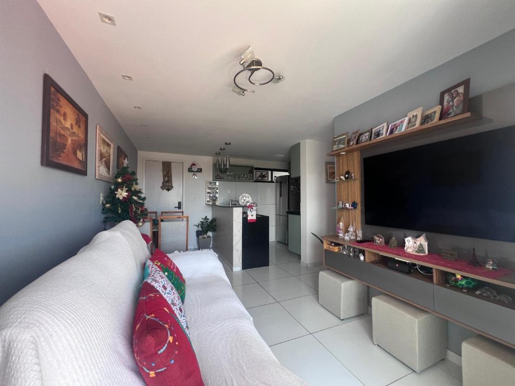a living room with a large flat screen tv at Quarto lovina e fest verão in Cabedelo
