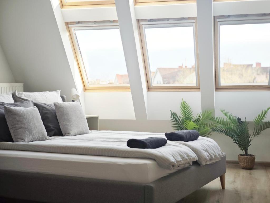 a bedroom with a bed with two pillows on it at GreenStreetApartment in Kecskemét