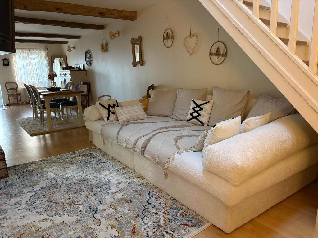 a living room with a couch and a staircase at Petit cocon à 5 min de Sedan in Sedan