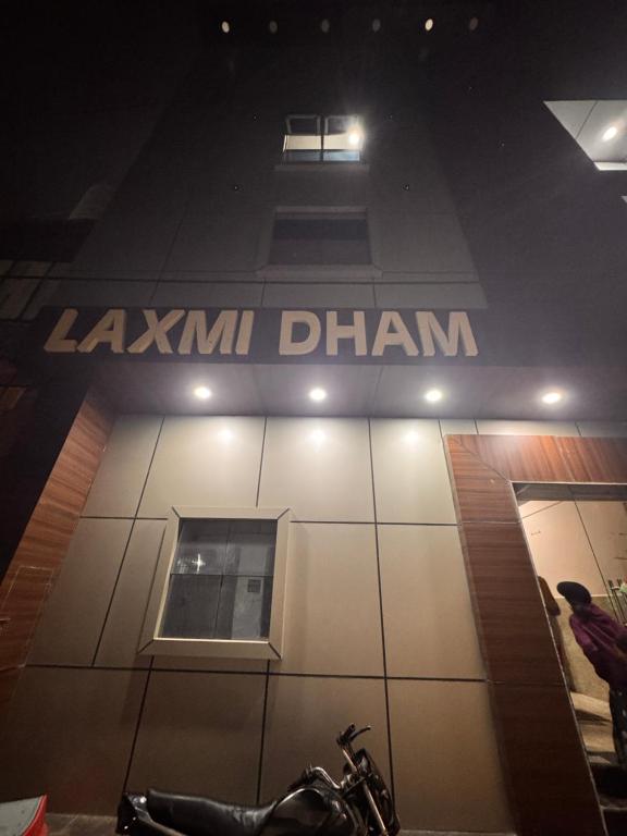 a motorcycle parked in front of a building at Laxmi Dham Guest House in Chhatikara
