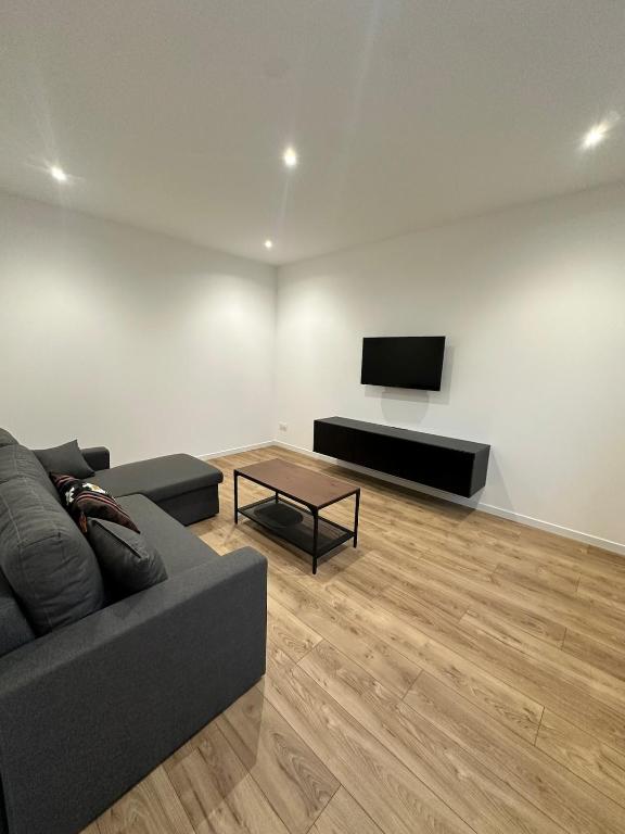 a living room with a couch and a flat screen tv at Maison de ville a Berck in Berck-sur-Mer