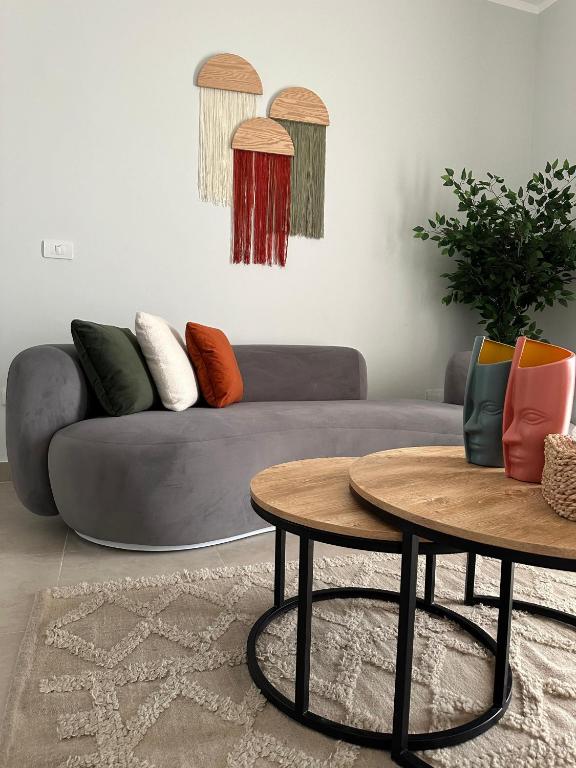 a living room with a couch and two tables at Babushka Boutique Hotel-Dahab in Dahab