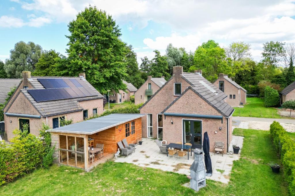 an aerial view of a house with solar panels on the roof at 6 - Person 'de Vlaamse Reus' 195 Bungalow in Ewijk