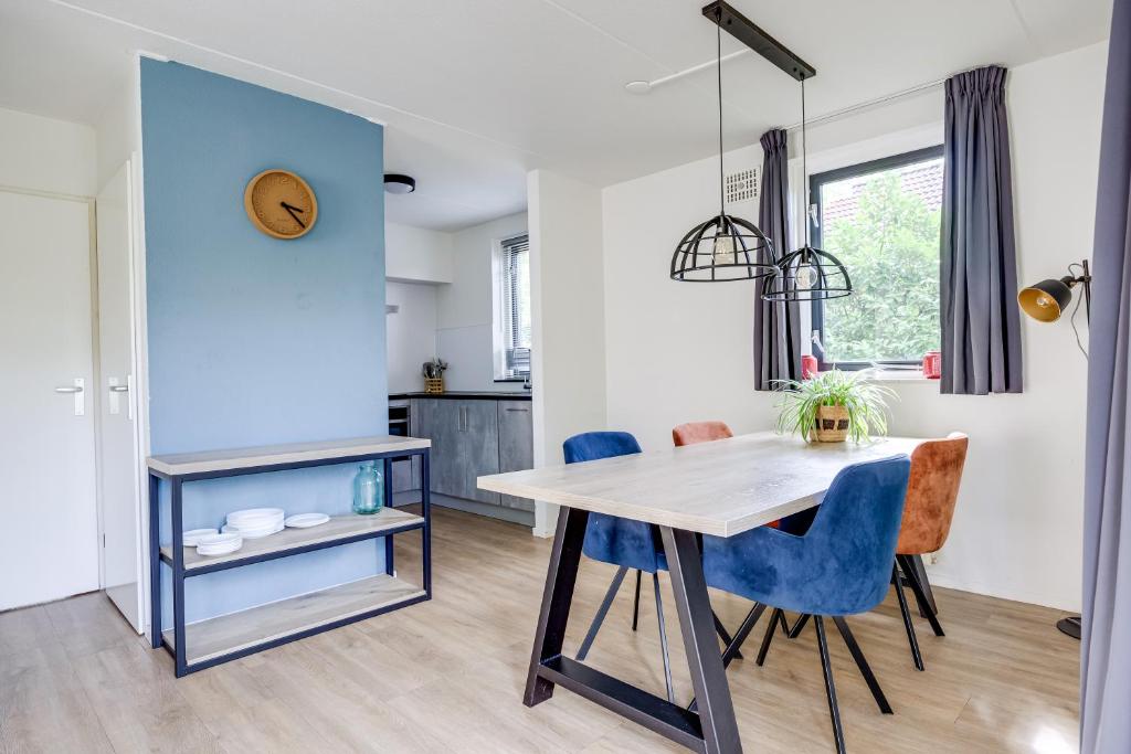 a kitchen and dining room with a table and chairs at 4 - Person Lakeside 47 Bungalow in Ewijk