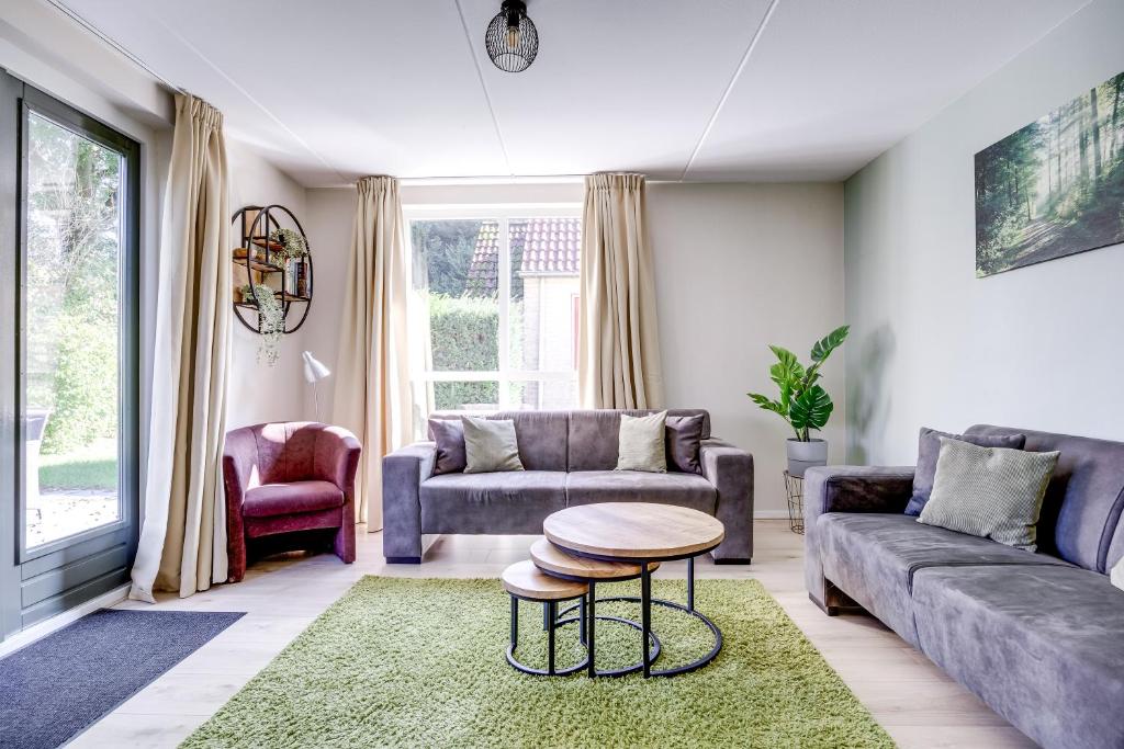 a living room with a couch and a table at 6 - Persons Lake Area 40 Bungalow in Ewijk