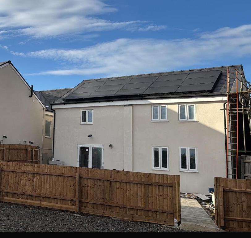 a house with a solar roof on top of it at Cherry Barn Haven in Wisbech Saint Mary