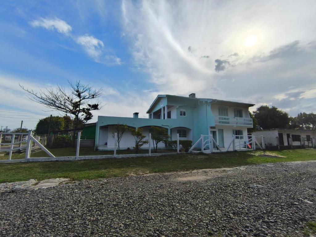 a house on the side of the road at Vida Mansa Apartamentos in Capão Novo