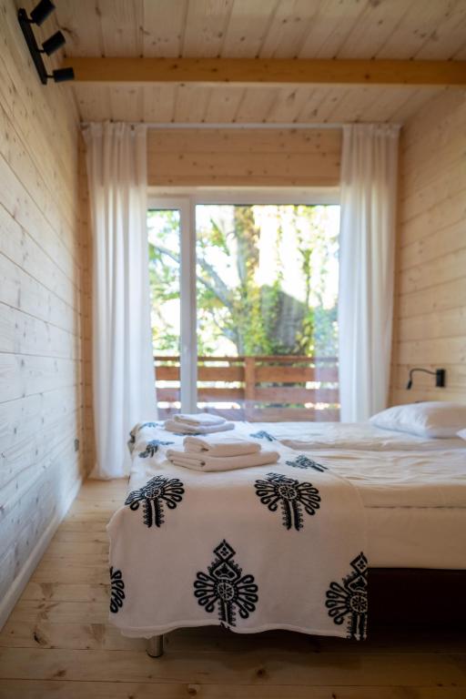 a bedroom with a bed and a large window at Poncyljuszówka in Szczyrk