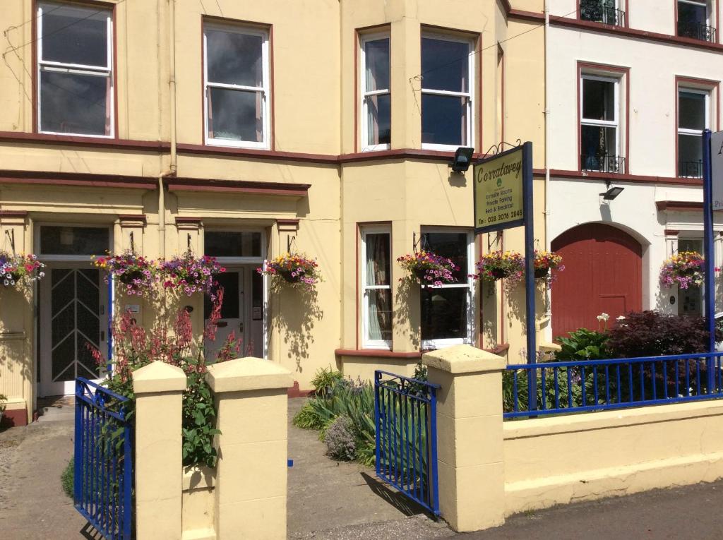 a building with flowers on the front of it at Corratavey Guest Accommodation in Ballycastle