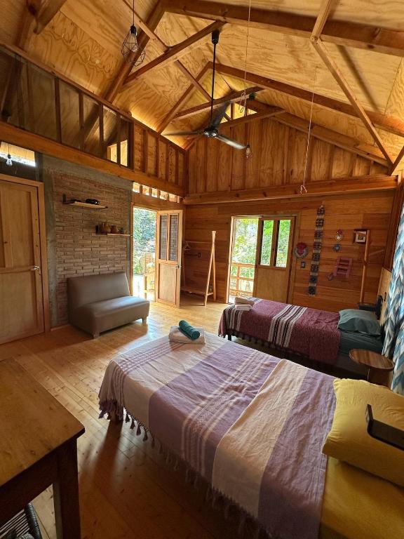 a large room with two beds and a couch at KAO Cabin in Brisas de Zicatela