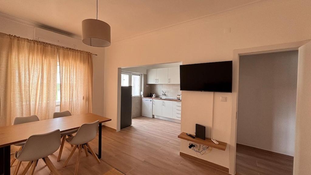 a kitchen and dining room with a table and chairs at Park Apartment - 2 Room APT in Lavradio