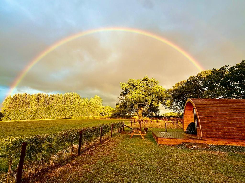 a rainbow in the sky over a field at Rainbow View in Ellesmere