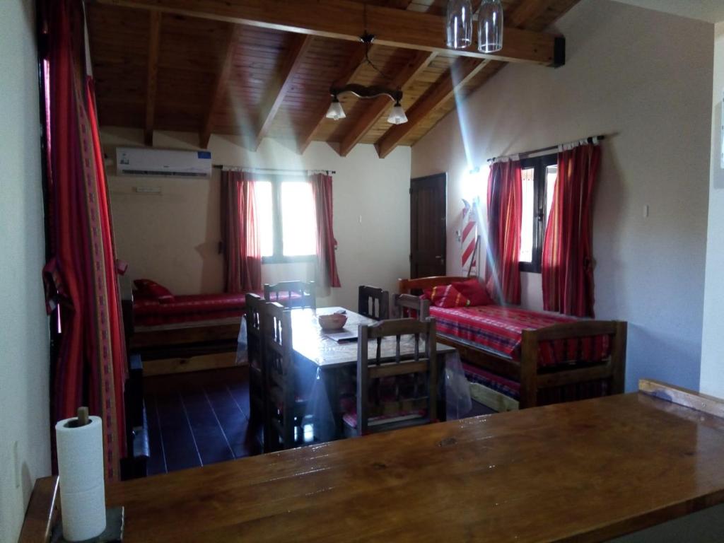 a room with a table and chairs and a living room at Cabañas Soledad in Potrerillos