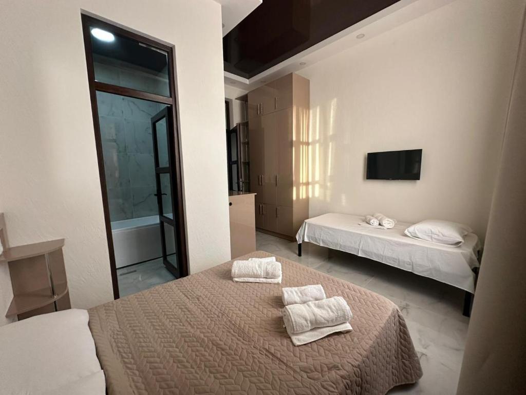 a bedroom with two beds with towels on them at villacaptaingomi in Gomi