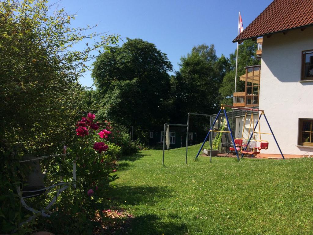 a yard with a swing set in the grass at Ferienwohnung Rhöner Luft in Bad Brückenau