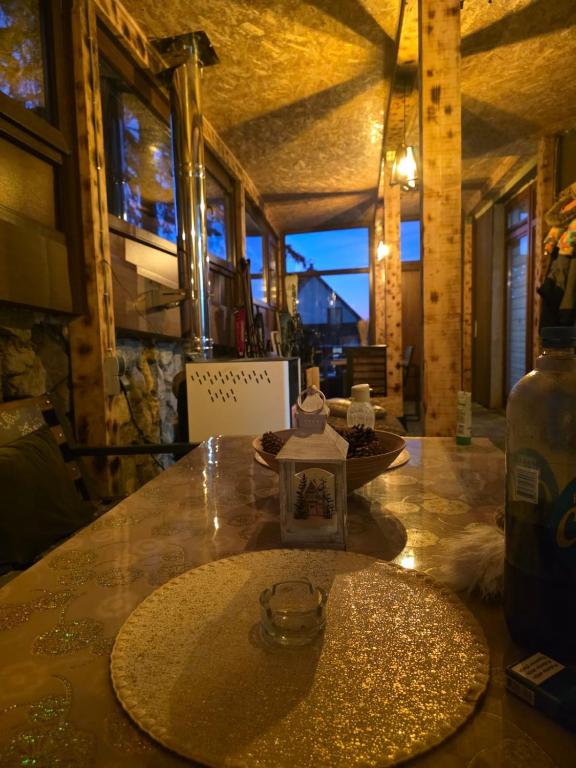 a table with a bottle on top of it at Apartmani Planinsko srce Vlašić in Vlasic