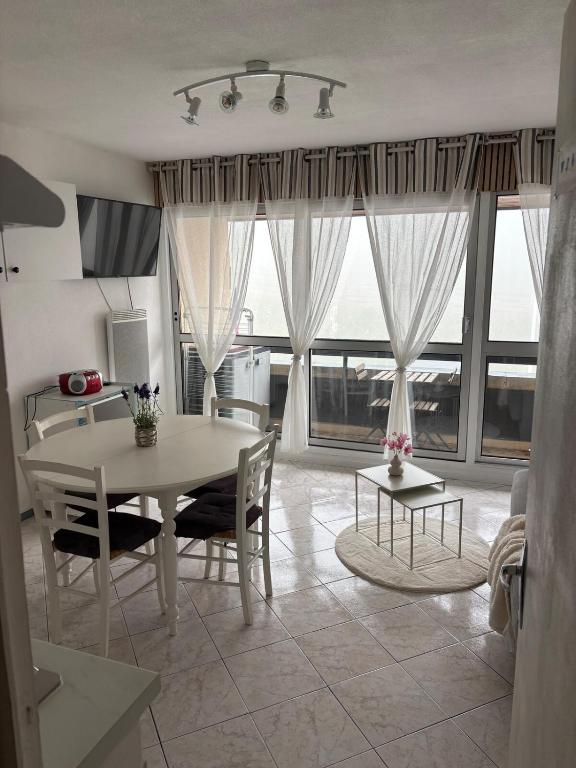 a kitchen and dining room with a table and chairs at Résidence MAYA in Saint-Lary-Soulan