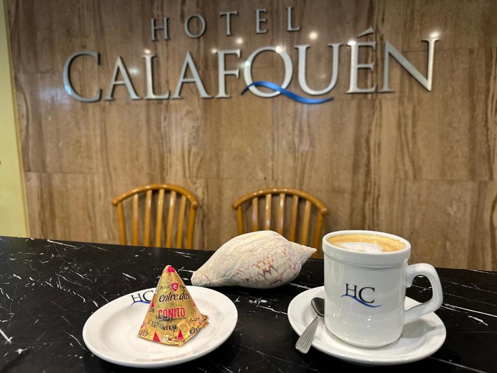 a cup of coffee and a cookie on a table at Calafquén in San Antonio Este