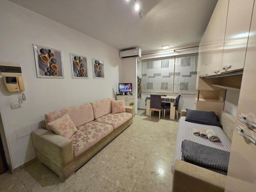a living room with a couch and a table at City Center Piazza Studio in Tirana