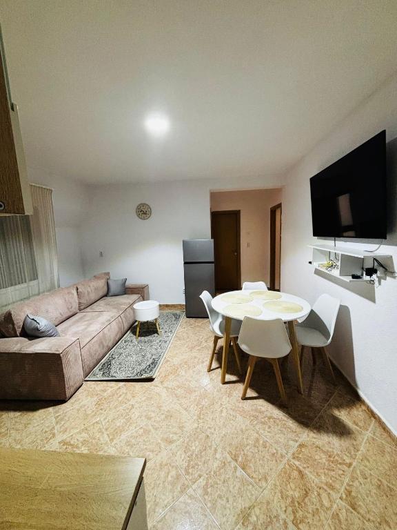 a living room with a couch and a table at Apartament Cozy in Gherla