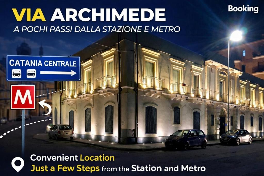 un cartello davanti a un edificio di notte di EUREKA APArtment a Catania