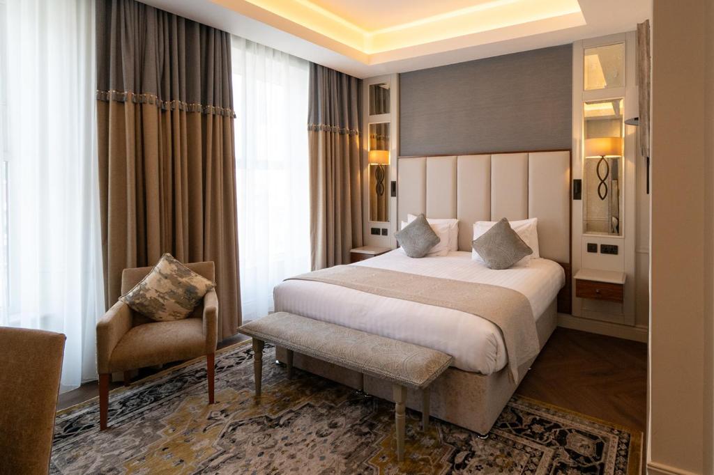 a hotel room with a bed and a chair at Grand Hotel Tralee in Tralee