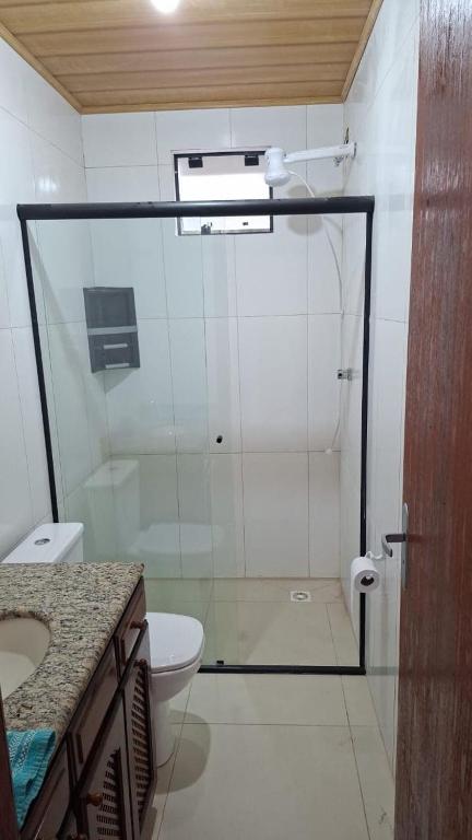 a bathroom with a shower with a toilet and a sink at Aluguel diária in Florianópolis