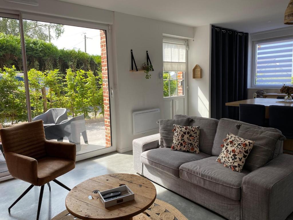 a living room with a couch and a table at Chez Aurel et Nico in Frélinghien