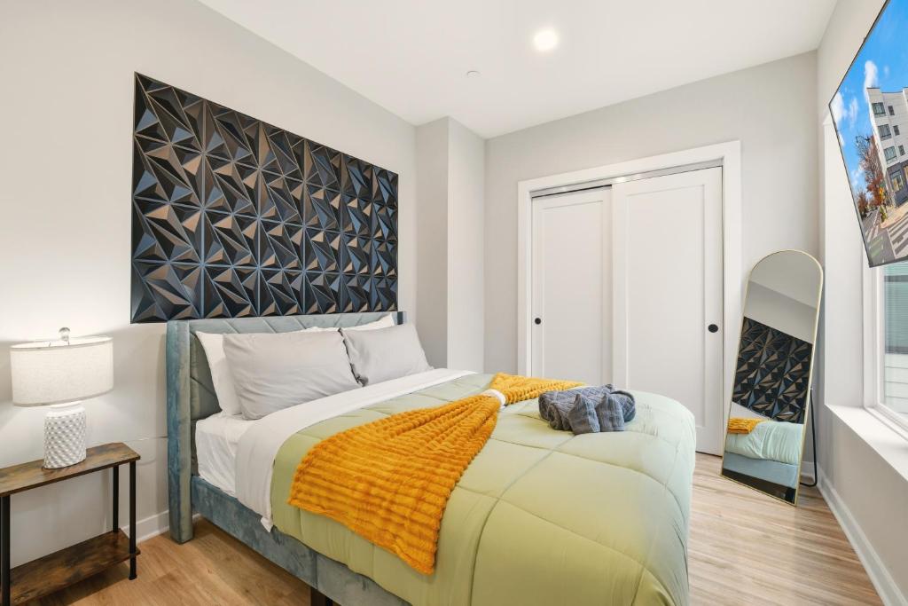 a bedroom with a large bed with a large headboard at LUX 1 BD Apartment In Union Market in Washington, D.C.