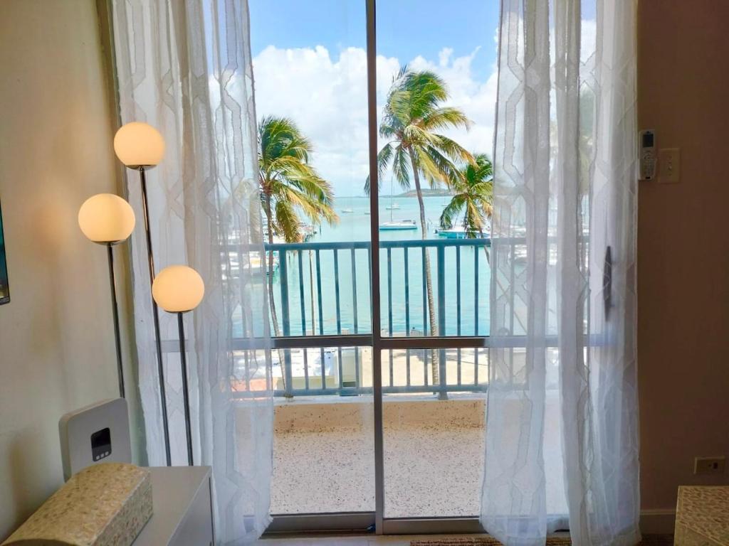 a room with a large window with a view of the ocean at Island bliss apartment in Fajardo