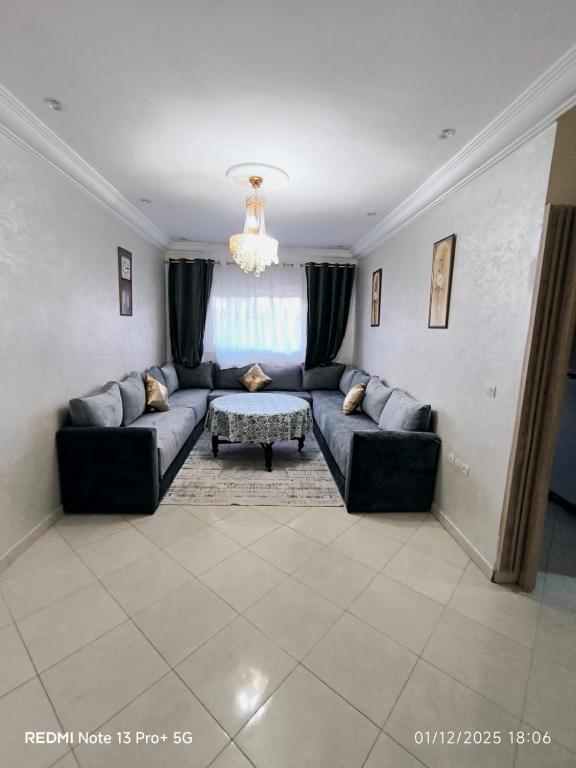 a living room with a couch and a table at Appartement in Mohammedia