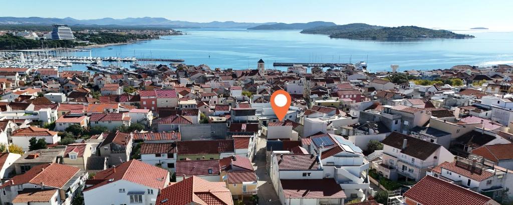 an aerial view of a city with houses and water at House Brunac with parking in Vodice