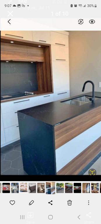 a kitchen with a sink and a counter top at Very large room in Montreal