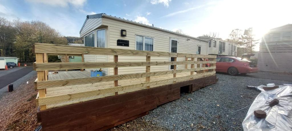 a house that is being built in front of a trailer at BZ Green Haven Caravan in Ballantrae