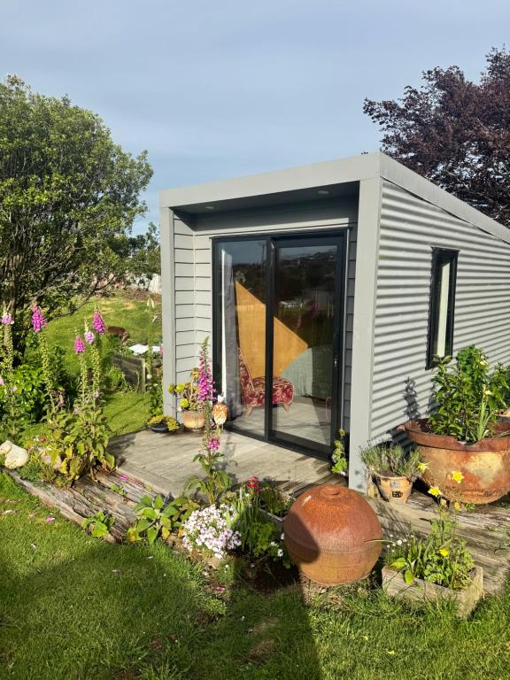 a small shed with plants in a garden at Harbourview Hideaway in Riverton