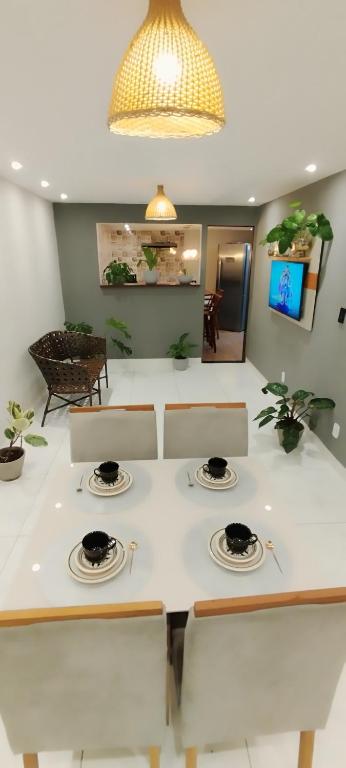 a kitchen with a table with plates on it at Doce lar in Búzios