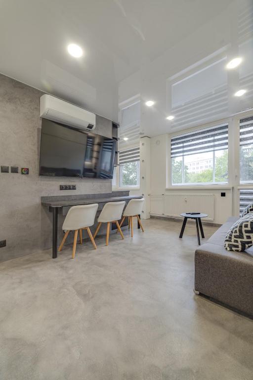 a living room with a table and chairs and a couch at AR Rezidencia Rosná in Košice