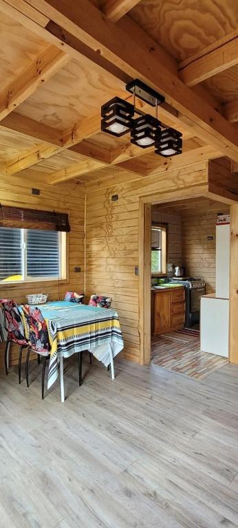 a large room with a table and a kitchen at Cabañas Donde Gaspar in Dalcahue