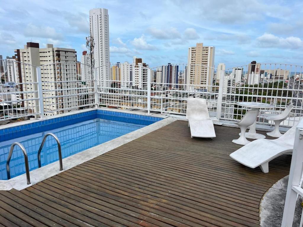 a balcony with a swimming pool on top of a building at Flat Manaira, lado do Manaira Shopping in João Pessoa
