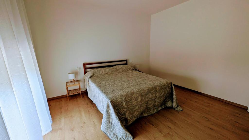 a bedroom with a bed and a wooden floor at Apartment with great views on Lake Garda in Torri del Benaco