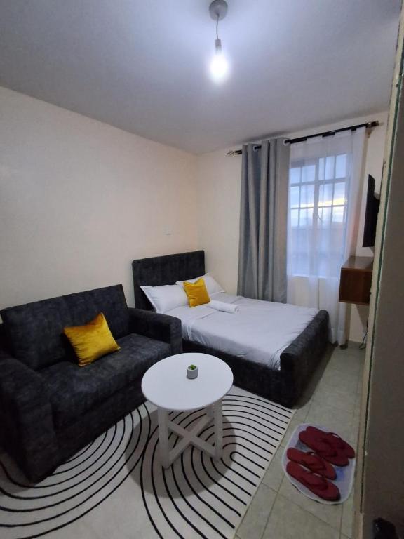 a living room with a couch and a table at Machakos Town Studios in Machakos